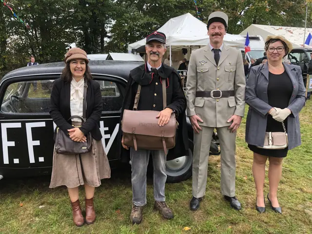 Bénévoles en costumes de la Libération devant la traction avant